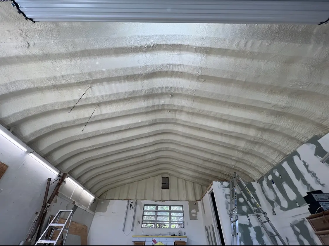 Spray polyurethane foam applied to the underside of a metal roof deck in Braselton
